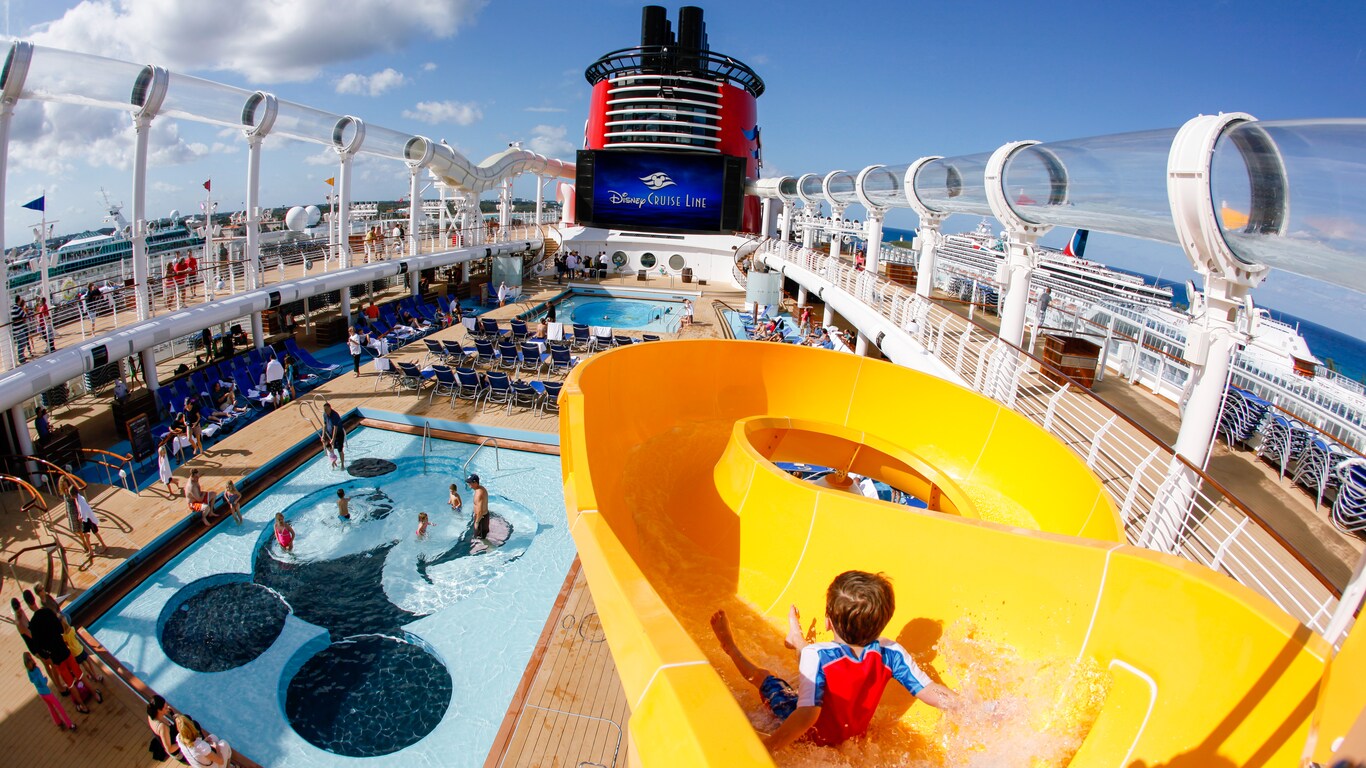 A small boy approaches a turn on the kid friendly waterslide overlooking Micky's Pool