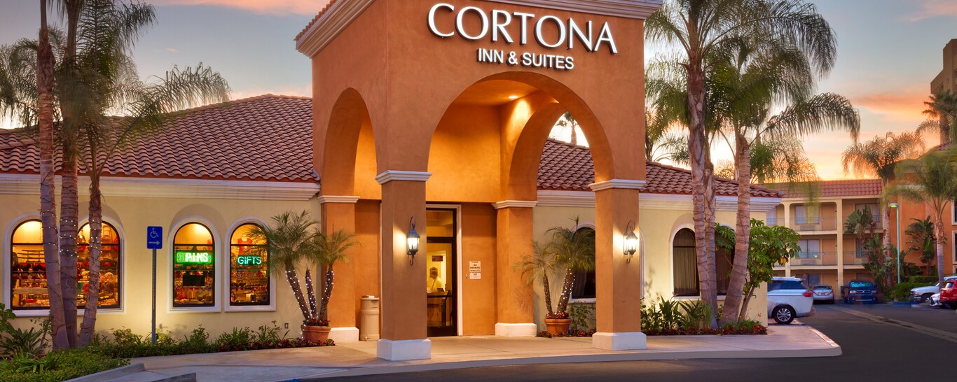 The parking lot and entrance to Mission-style Cortona Inn & Suites Anaheim Resort