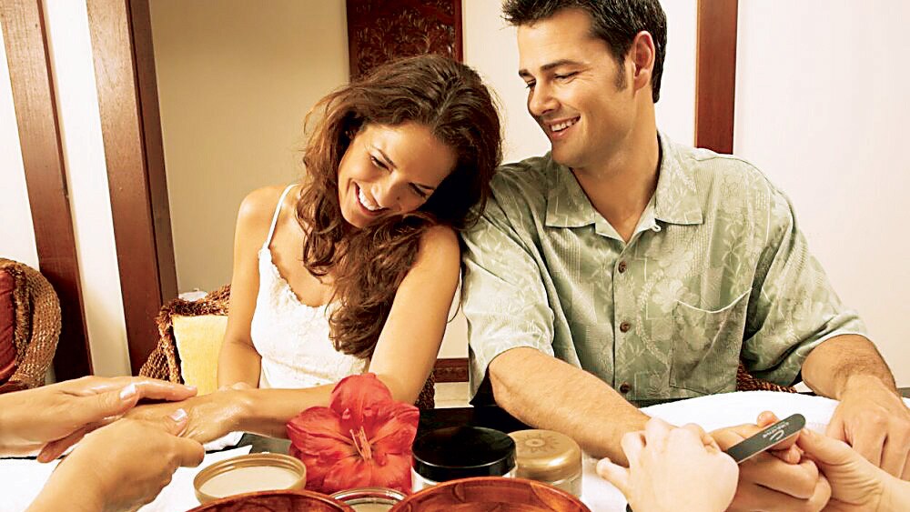 A couple enjoys getting a spa manicure together