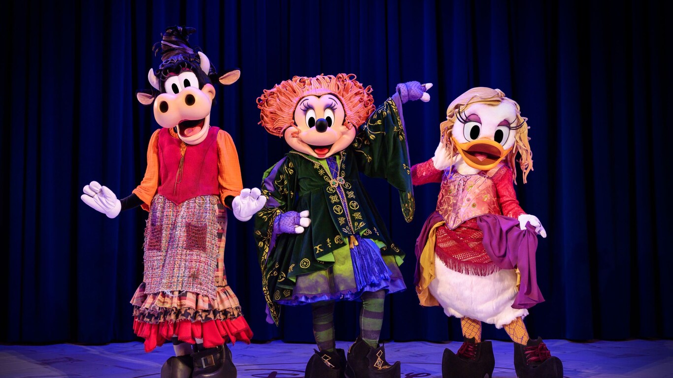 Clarabelle Cow, Minnie Mouse and Daisy Duck pose while dressed as the Sanderson Sisters from Hocus Pocus