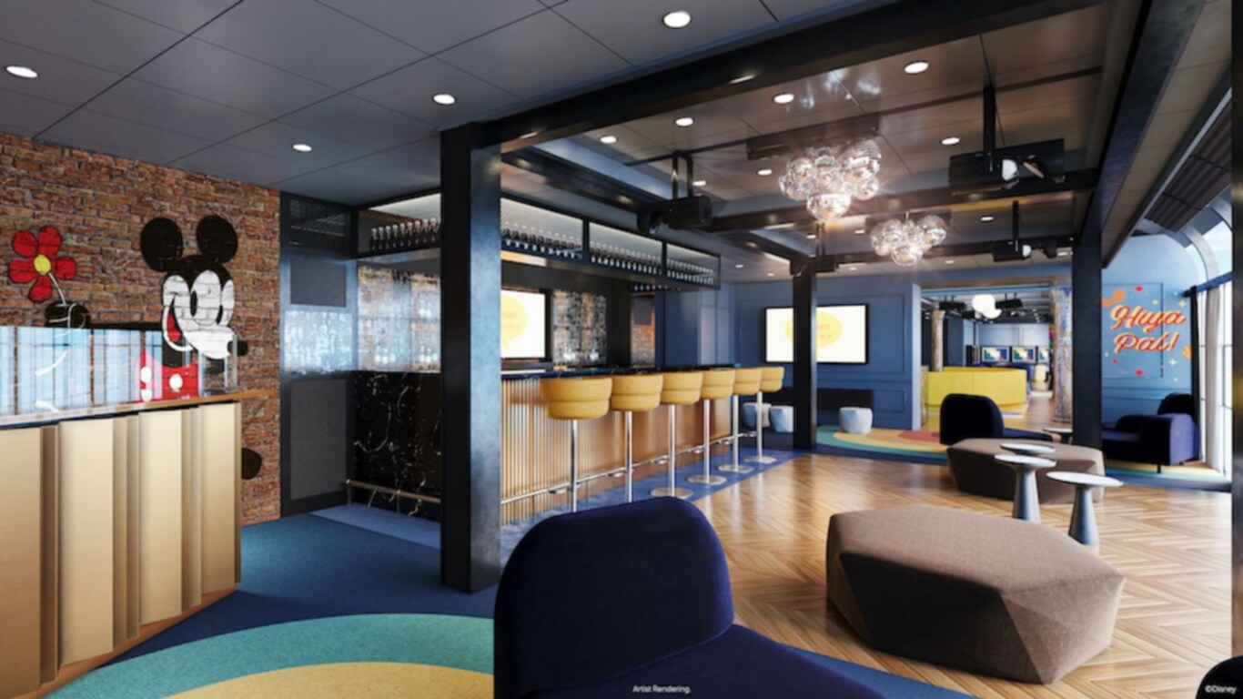 A club setting featuring a drink bar, stools, modular furnishings, a dance floor, disco balls, a large LED screen and retro Disney murals