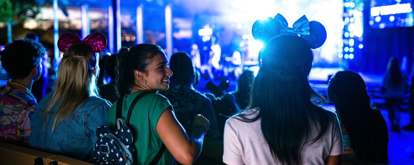 Guests enjoying a nighttime musical show from the Eat to the Beat Concert Series at Epcot
