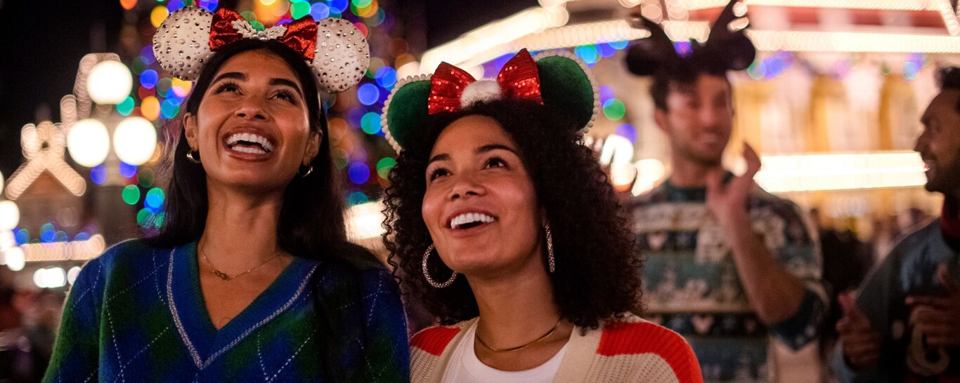 A family of 4 experiencing snowflakes during Holidays at Walt Disney World Resort