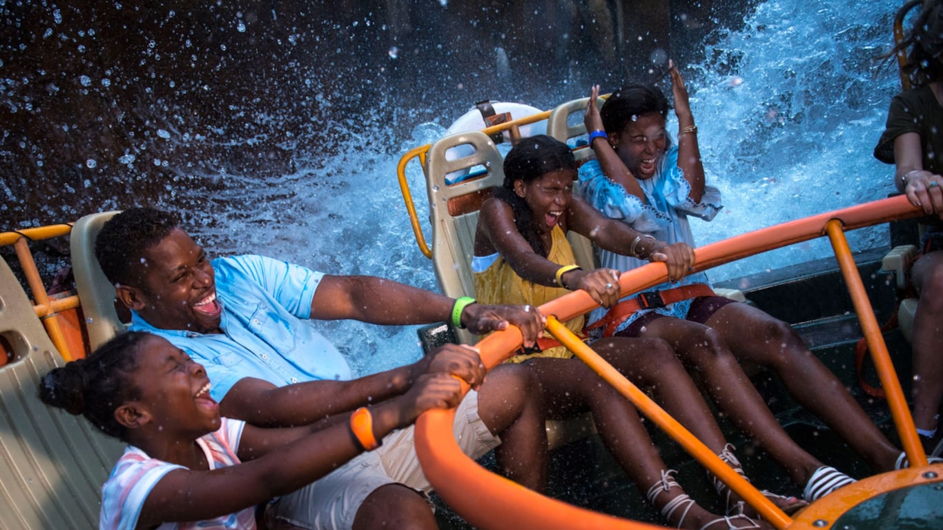 A dad and his kids get splashed on Kali River Rapids