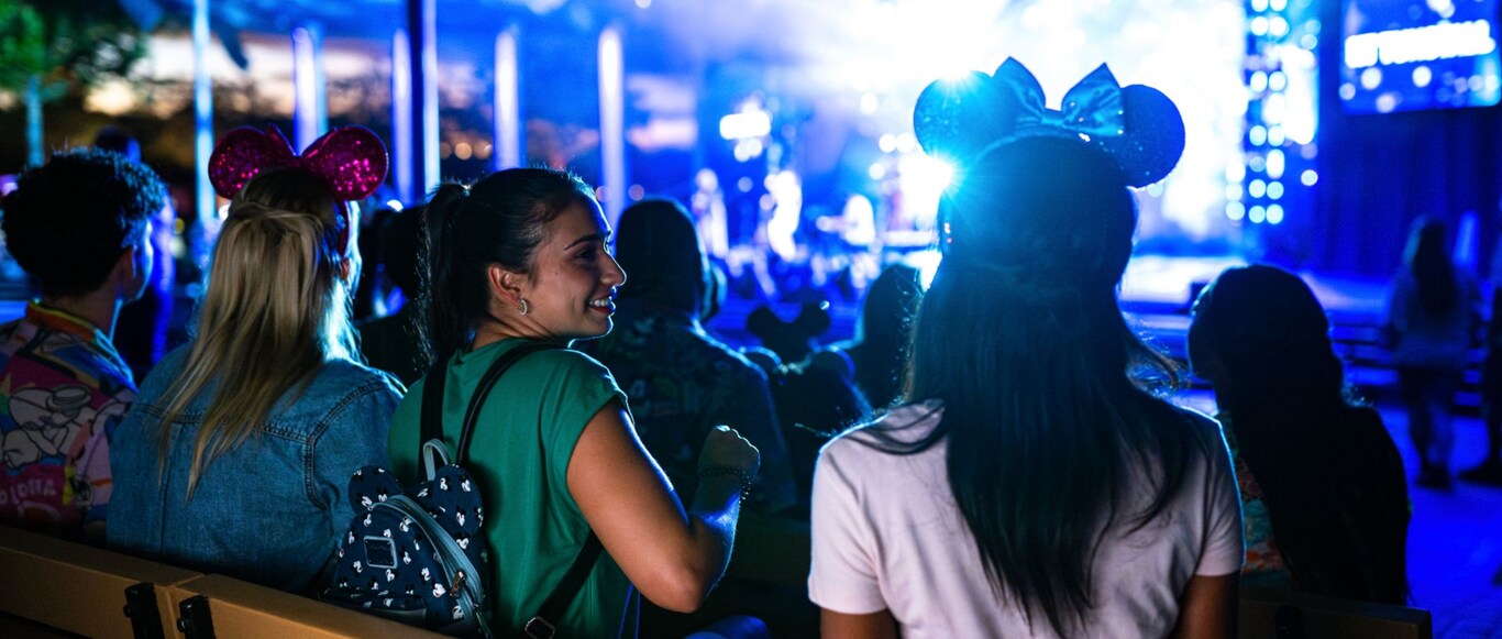 Guests enjoying a nighttime musical show from the Eat to the Beat Concert Series at Epcot