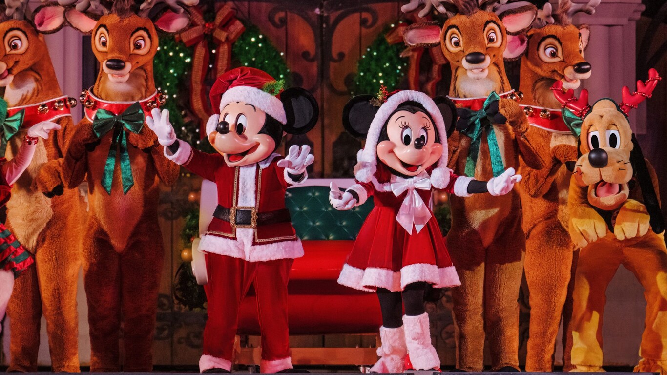 Mickey Mouse, Minnie Mouse, Pluto and a group of reindeer onstage during Mickey’s Most Merriest Celebration