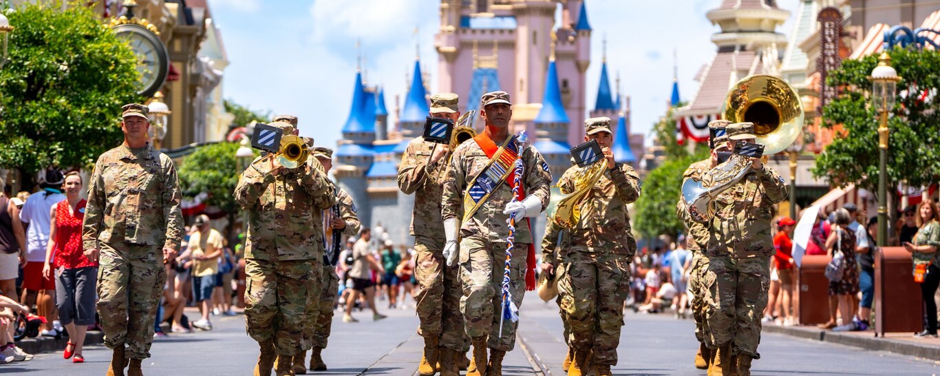 US military service members playing instruments as they march down Main Street, USA