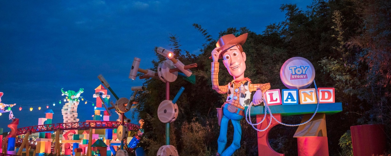 The entrance to Toy Story Land, featuring a giant Woody figure and oversized toys