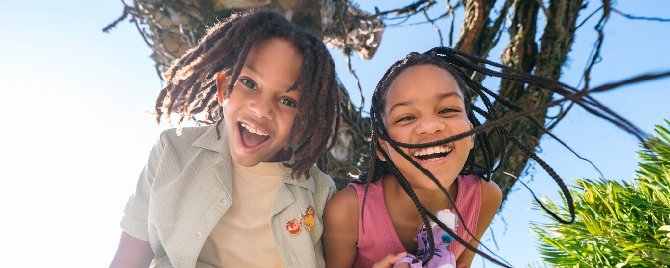 2 smiling children surrounded by lush foliage in Pandora – The World of Avatar at Disney's Animal Kingdom theme par