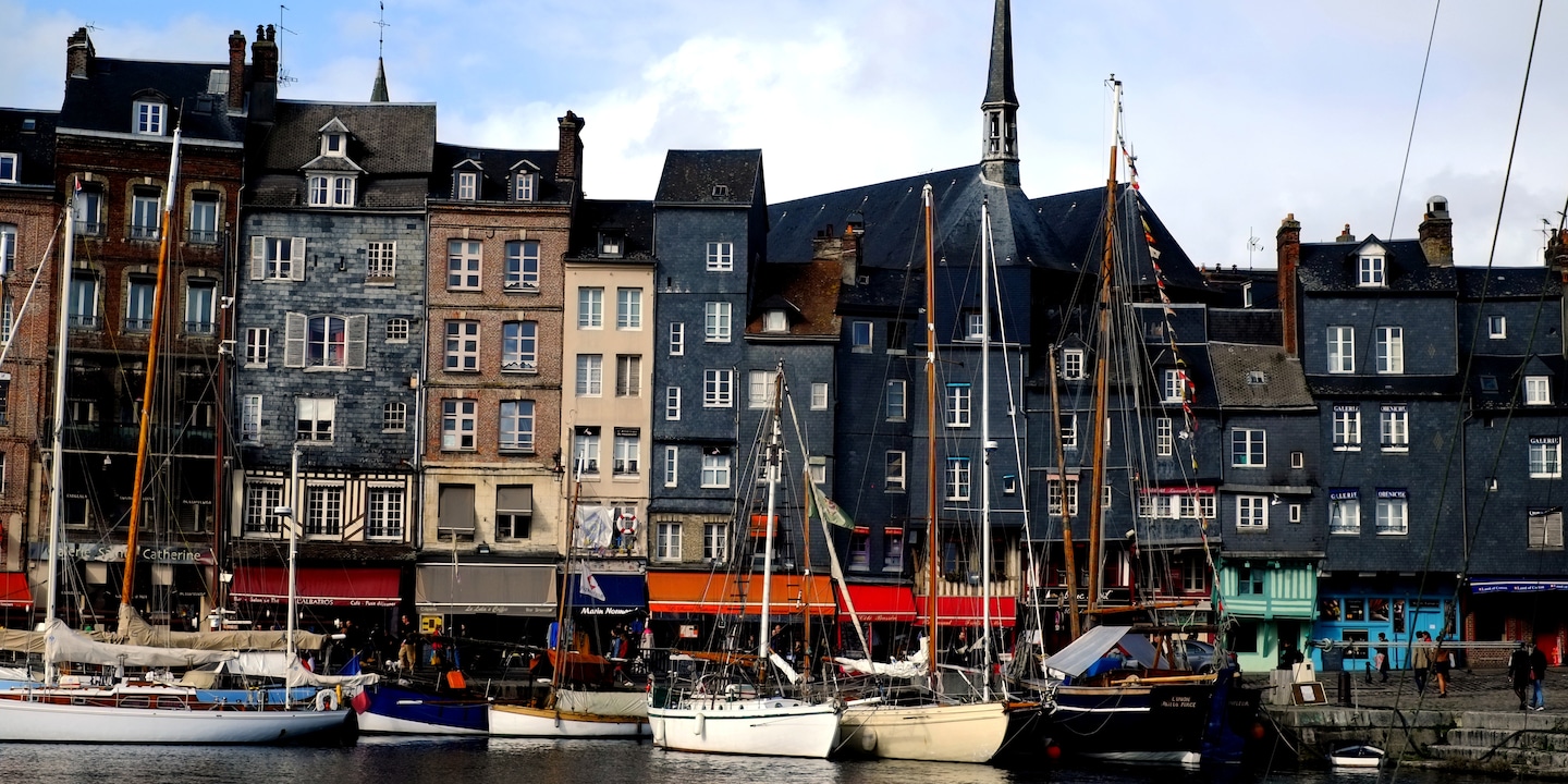 Boats anchored in the harbor of the coastal town of Honfleur