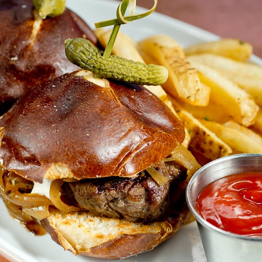 Sink your teeth into one of our flavorful handheld sandwiches like the Filet Mignon Sliders served with olive oil parsley fries or side salad. slide 55 of 12 Plated Filet Mignon Sliders served with a cornichon, olive oil parsley fries and a side of ketchup