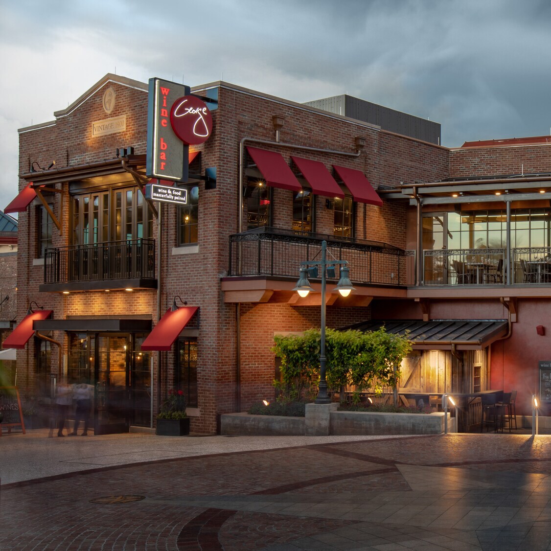 The exterior of Wine Bar George features balcony seating
