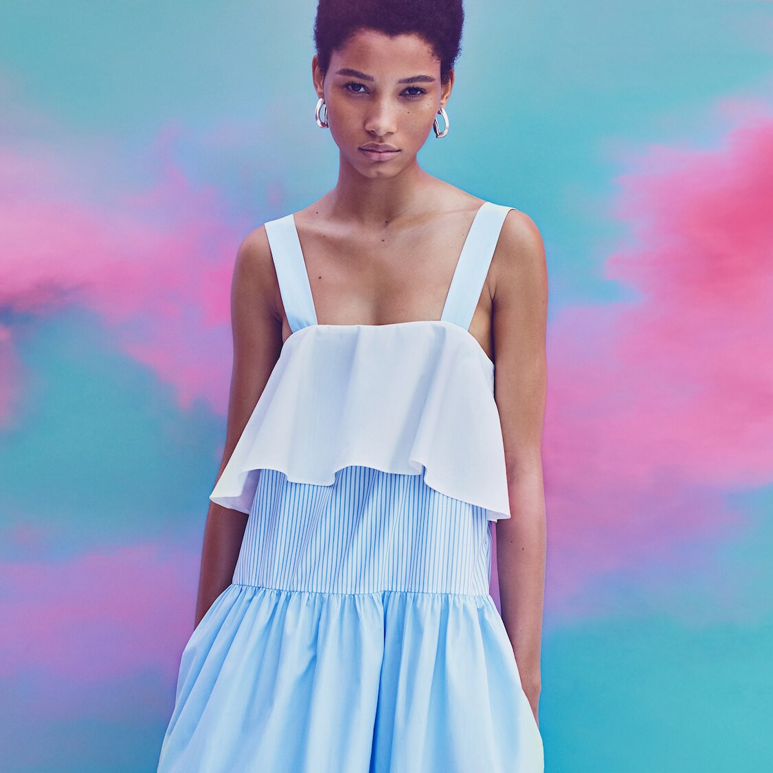 A woman models a tiered ruffle tank dress