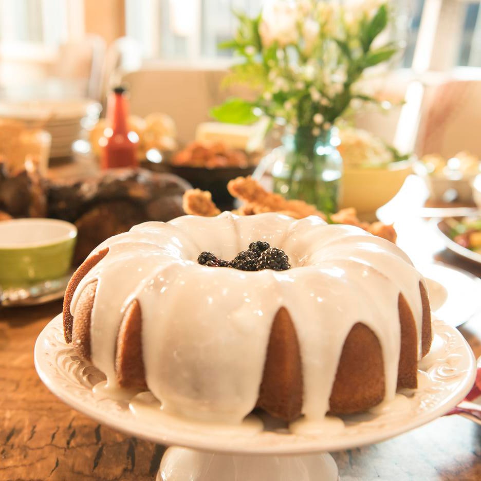 No Southern-style meal is complete without a slice of Chef Art's irresistible Moonshine cake. slide 31 of 7 Iced Moonshine Cake on a pedestal among assorted dishes