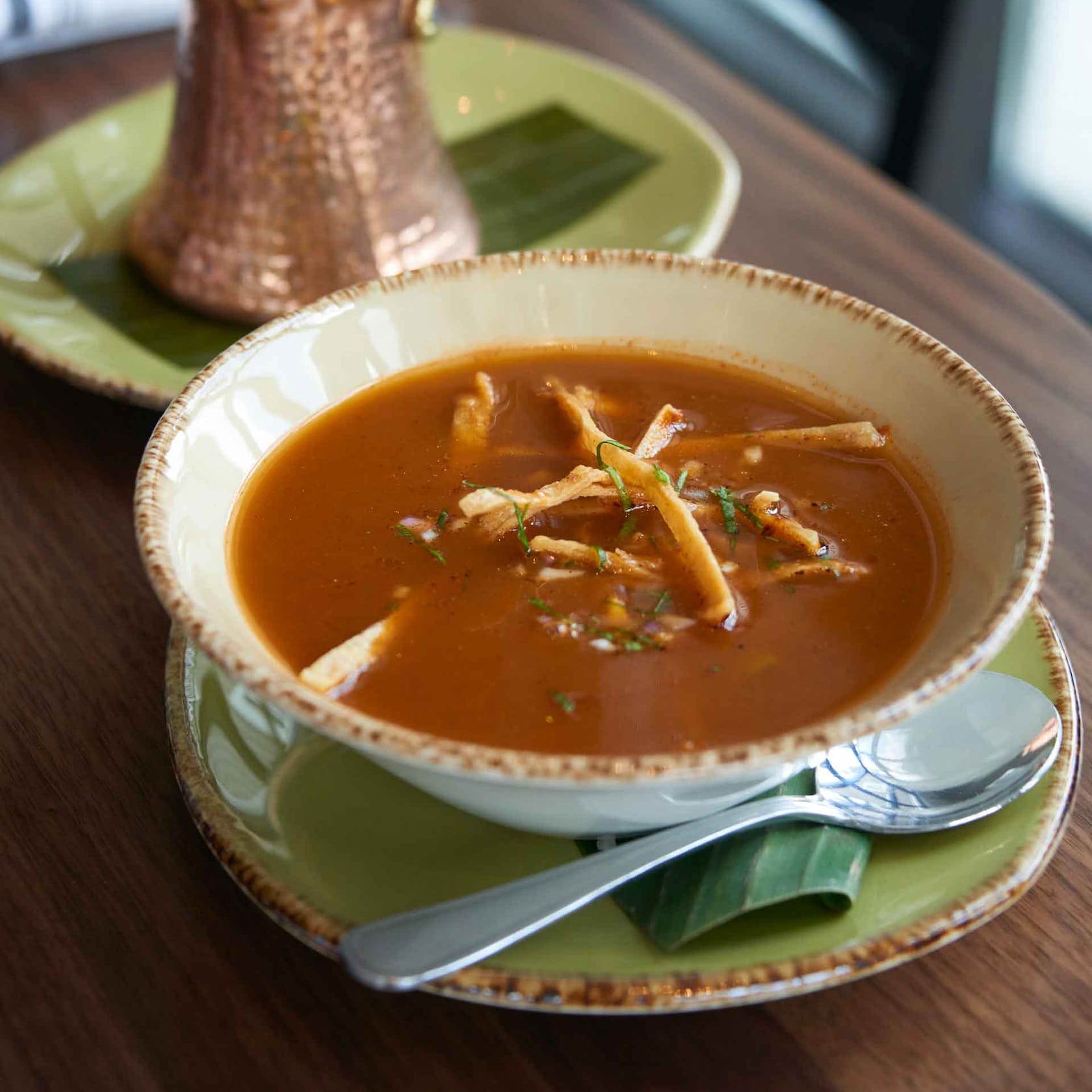Tuck into a yummy bowl of tortilla soup, loaded with chipotle chicken, avocado, Chihuahua cheese, tortilla strips and more. slide 73 of 16 A bowl of tortilla soup topped with chicken, avocado, cheese, onion, cilantro and tortilla chips