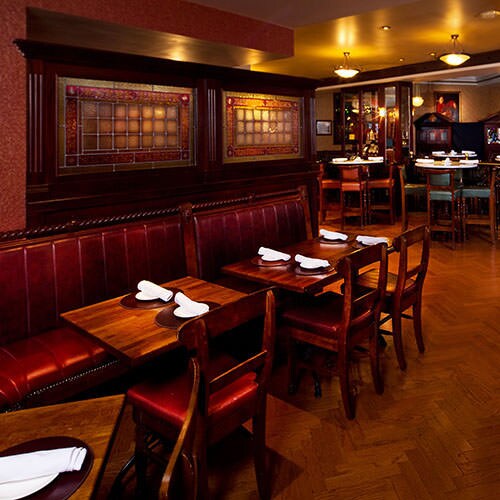 Banquette tables against the wall in an alternate dining area