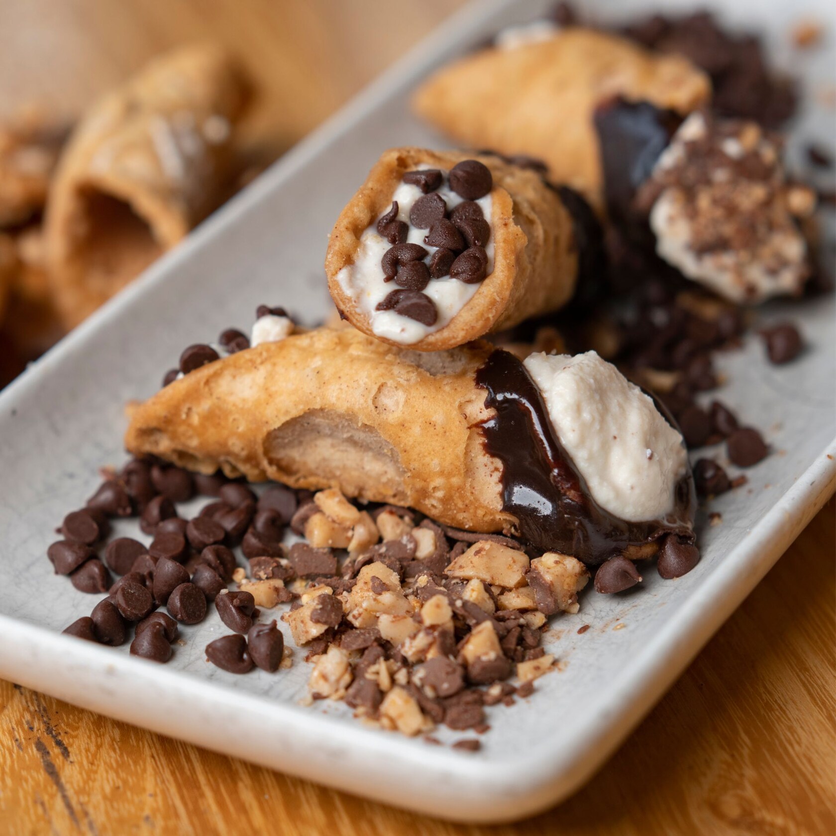 Cannoli served with melted chocolate and chocolate chips 