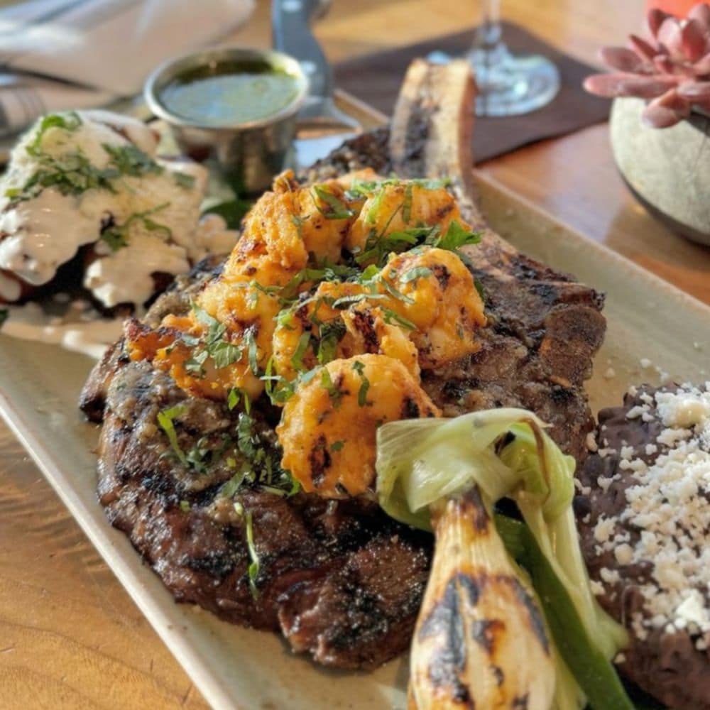 Taste classics like Carne Asada in new and delicious ways. slide 70 of 16 A plate of Carne Asada with shrimp from Frontera Cocina