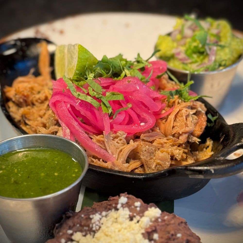 Enjoy a selection of mouthwatering offerings with a modern twist. slide 67 of 16 A plate of Carnitas from Frontera Cocina