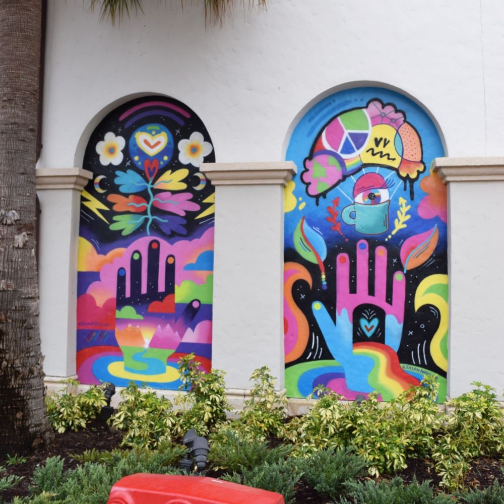 Two murals featuring abstract hands and geometric designs
