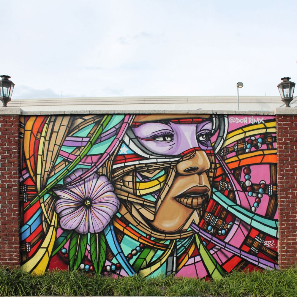 A mural of a woman’s face and a flower 