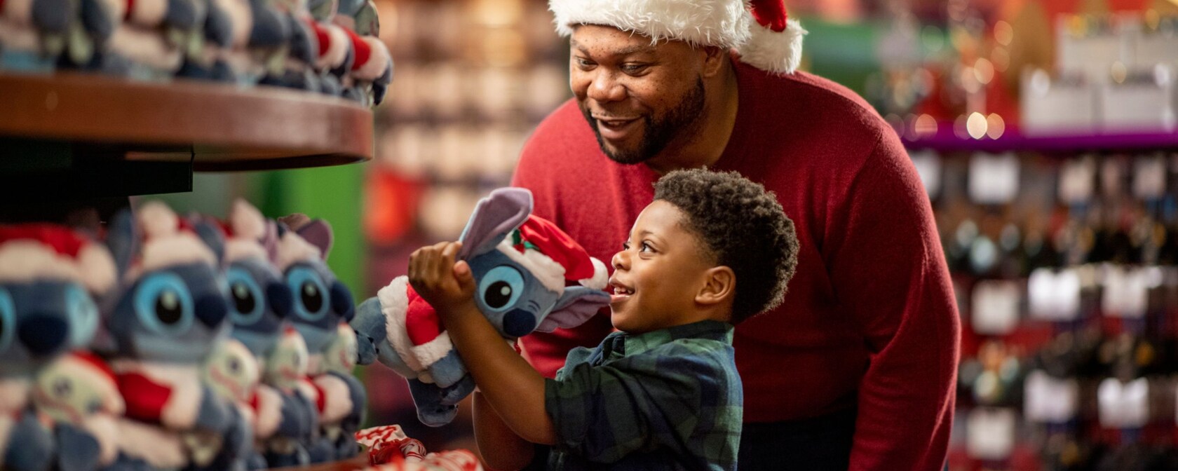 A kid and his father look at Stitch plushes