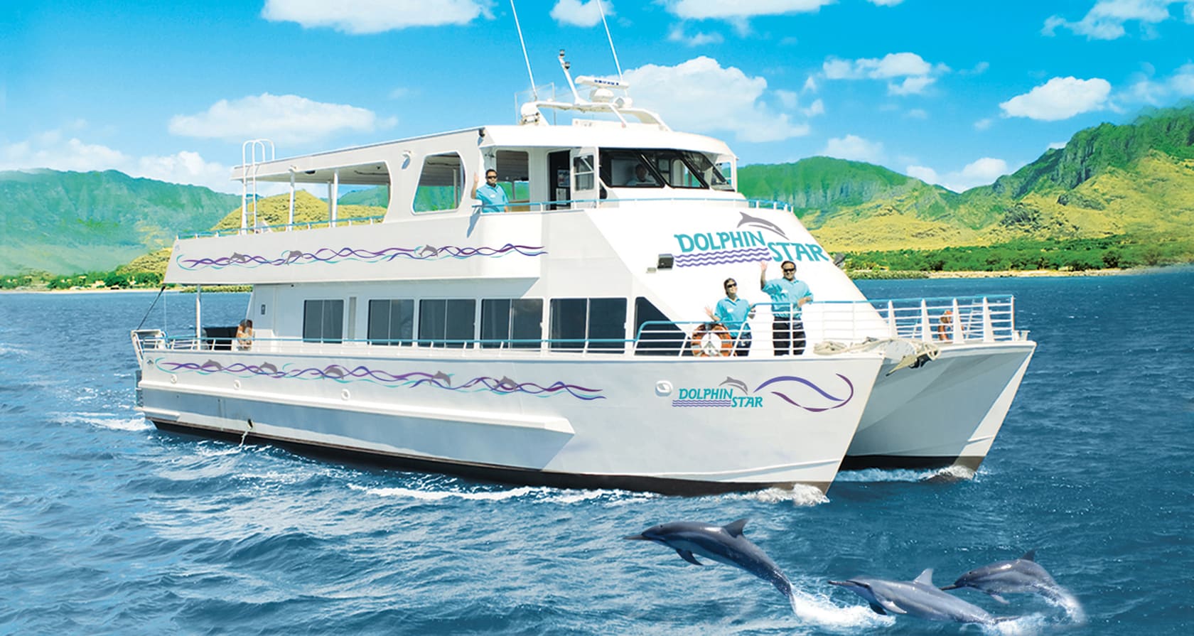 3 crew members wave from the decks of the Dolphin Star cruise ship and a trio of dolphins jump out of the water