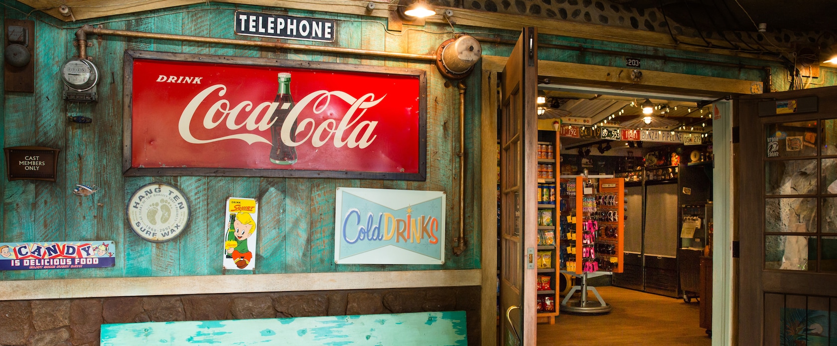 The exterior of Lava Shack snack shop, featuring weathered paint and vintage-style product signs