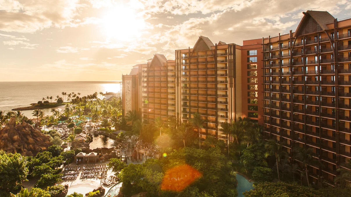 The three towers of Aulani Resort with a shining sunset in the background