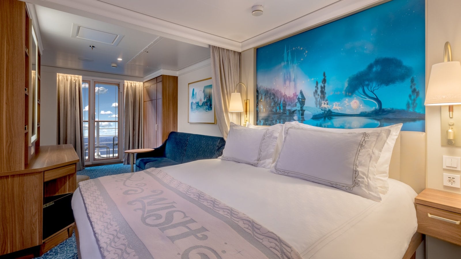 A spacious Verandah Stateroom aboard the Disney Wish with a mural inspired by the Disney animated movie Cinderella