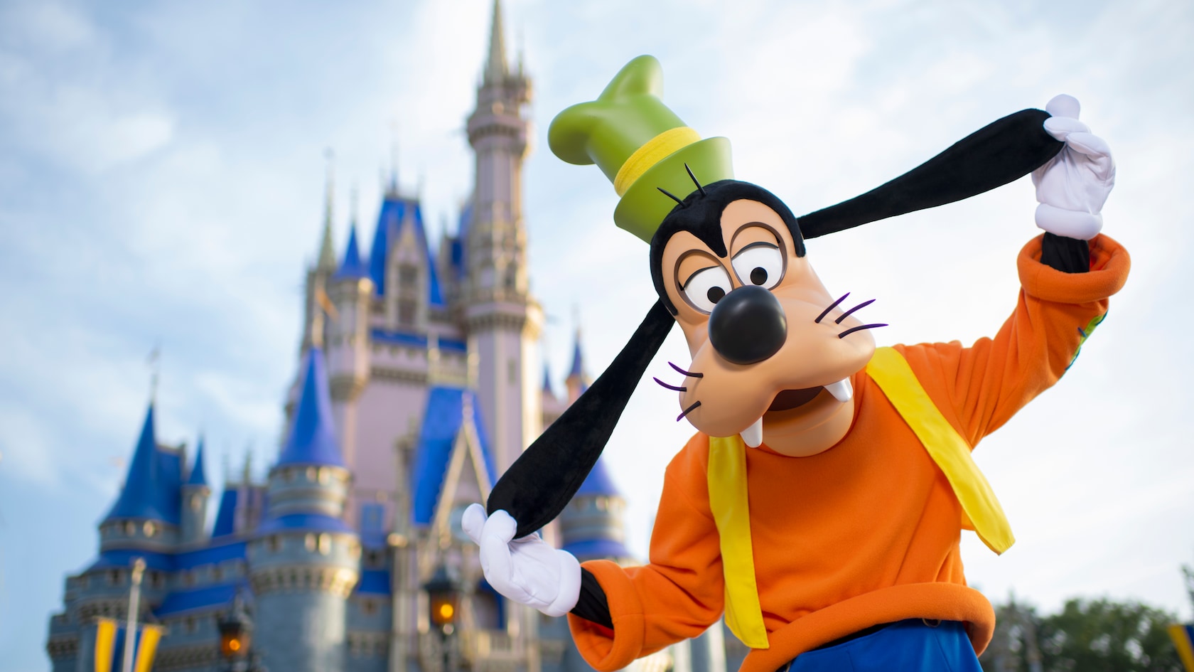 Goofy strikes a silly pose in front of Cinderella Castle