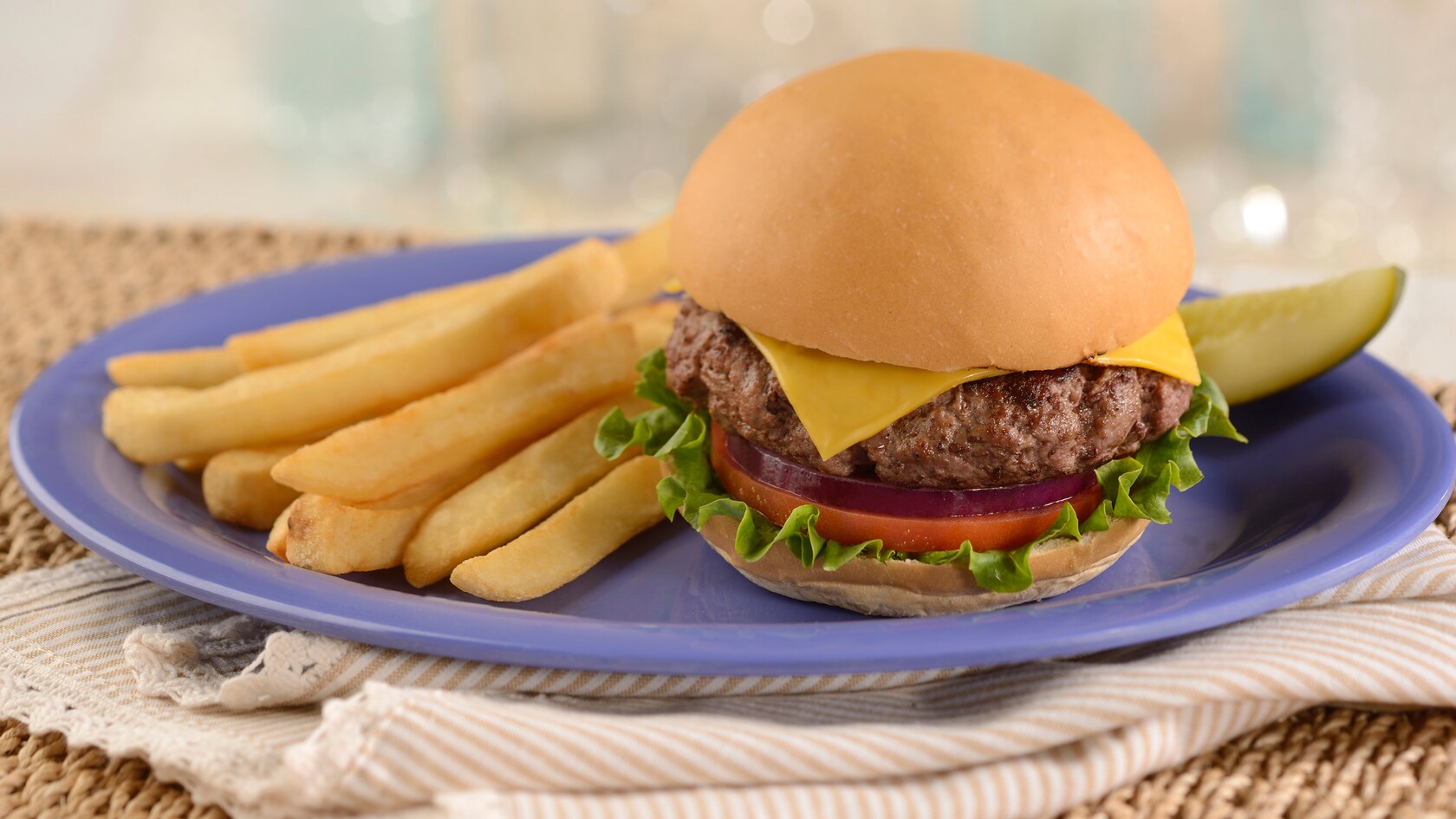 A cheeseburger and French fries on a plate