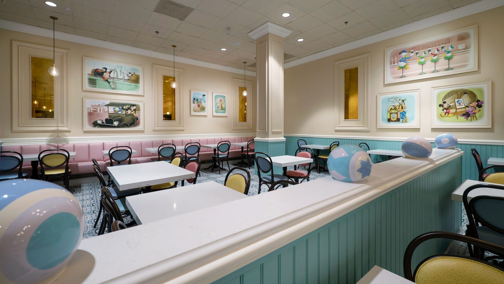 A restaurant seating area filled with chairs, tables and booths