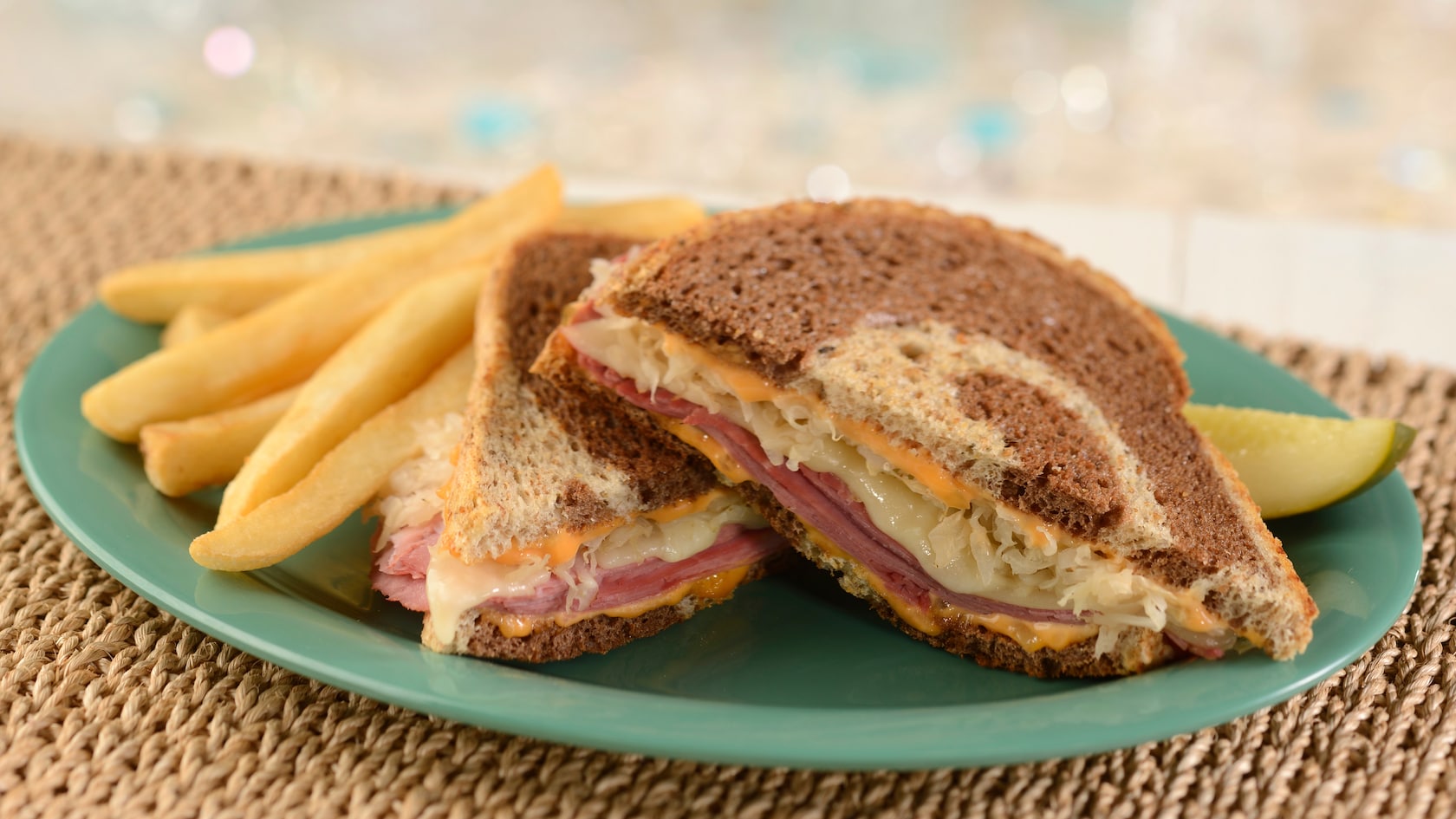 A Reuben sandwhcih and French fries on a plate