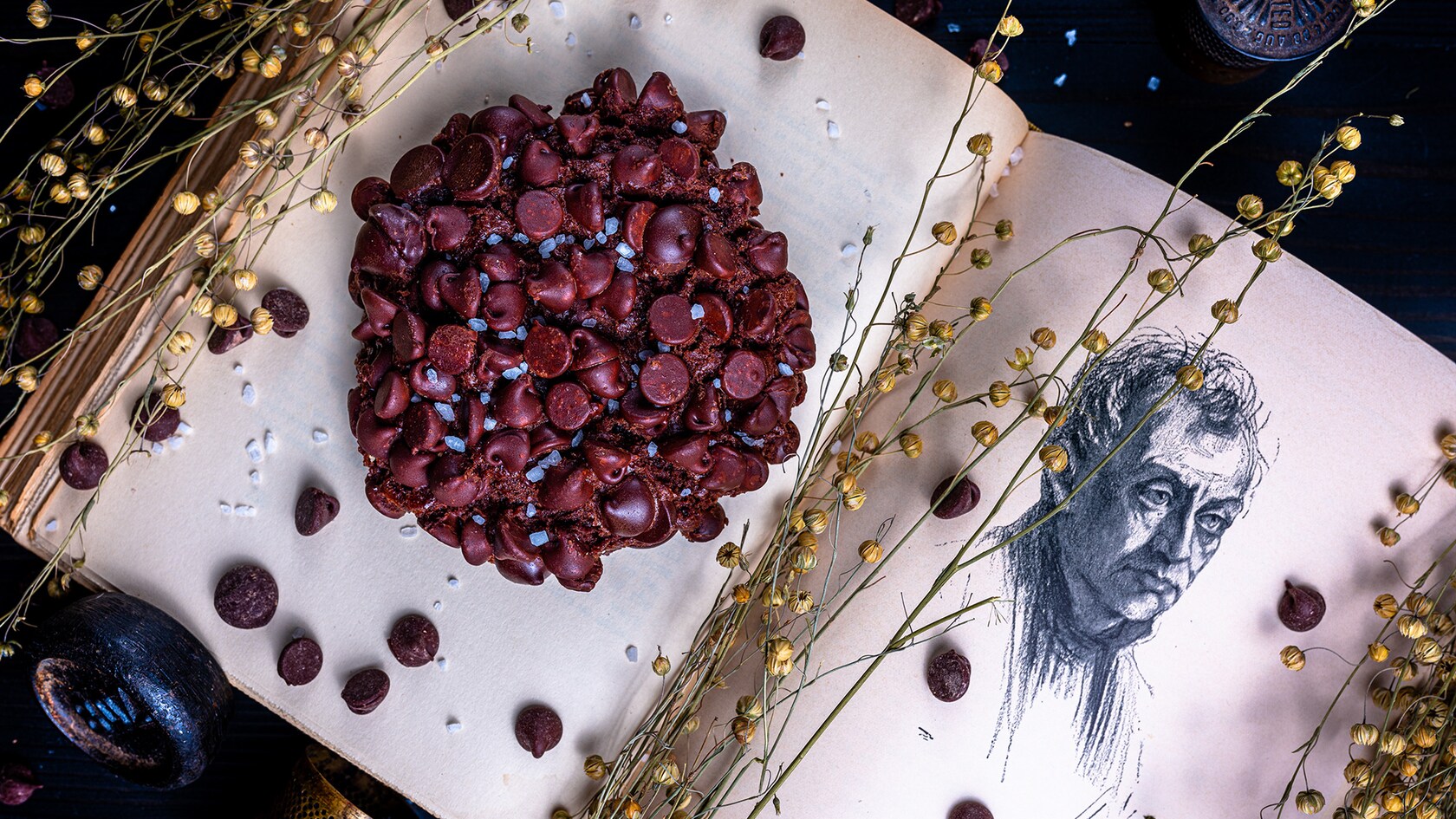 A Triple Chocolate Cookie laying on the page of an ancient book