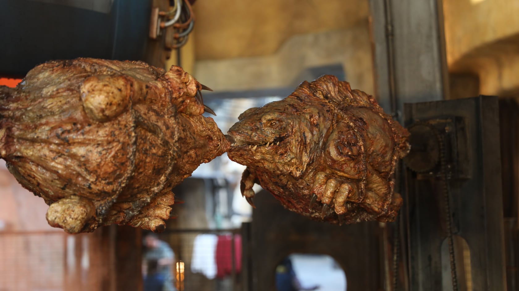 Two large chunks of ronto meat spinning on a rotisserie