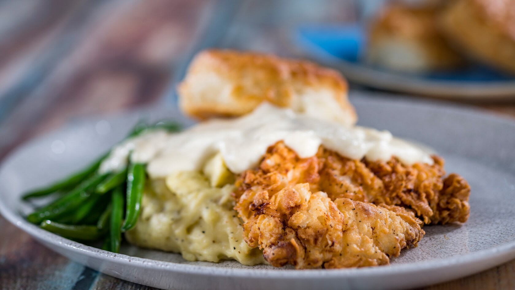 Buttermilk Fried Chicken served with gravy, asparagus and a biscuit