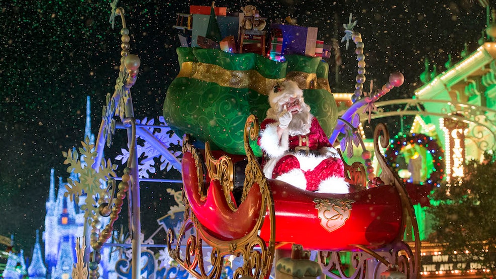 Papai Noel voa em um trenó repleto de brinquedos com um Cinderella Castle iluminado ao fundo