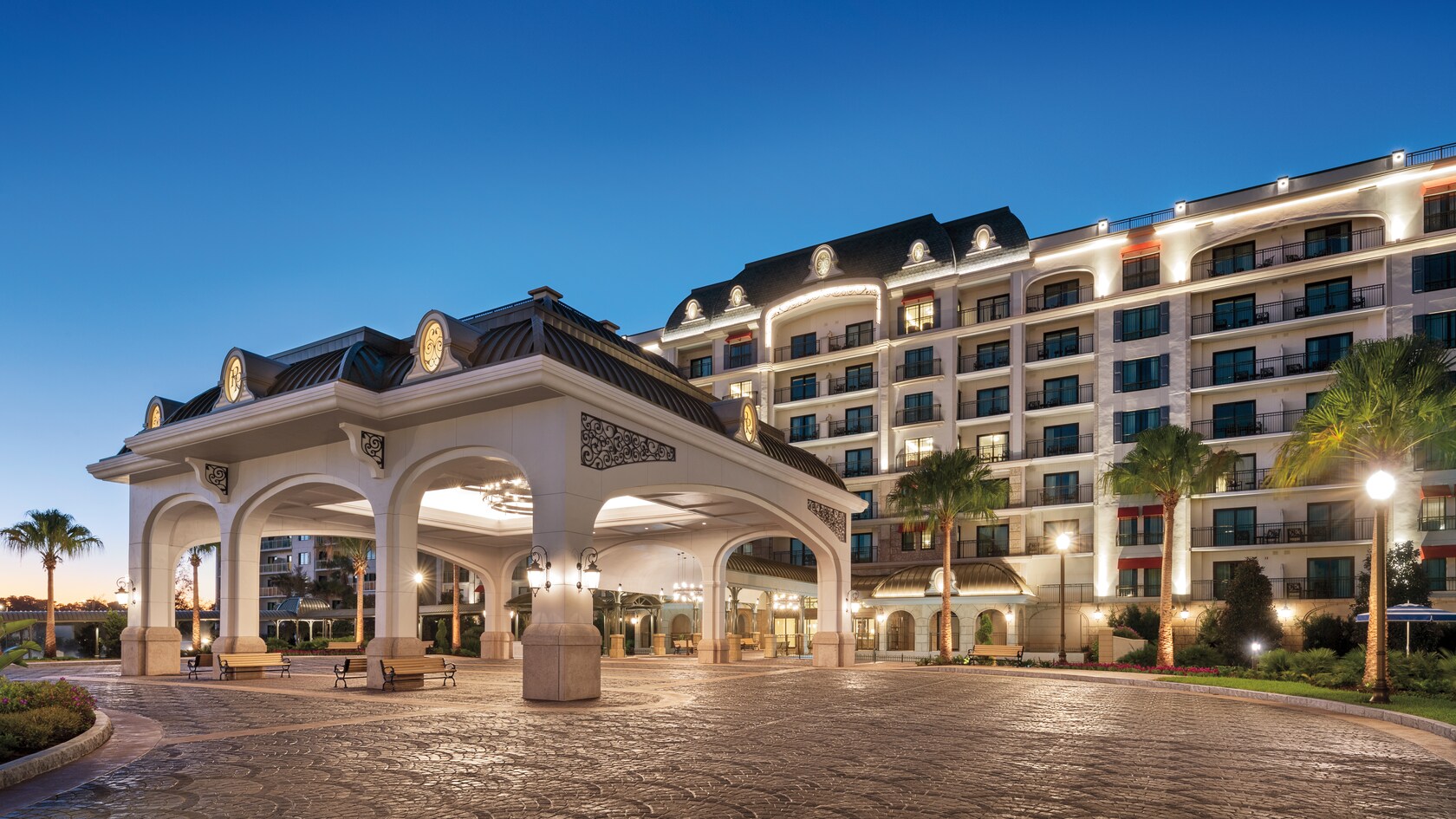 The illuminated exterior of Disney’s Riviera Resort
