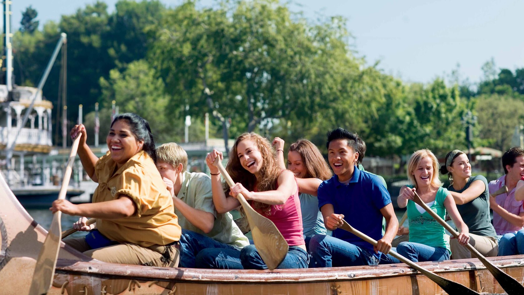 Several Happy Guests paddle a canoe
