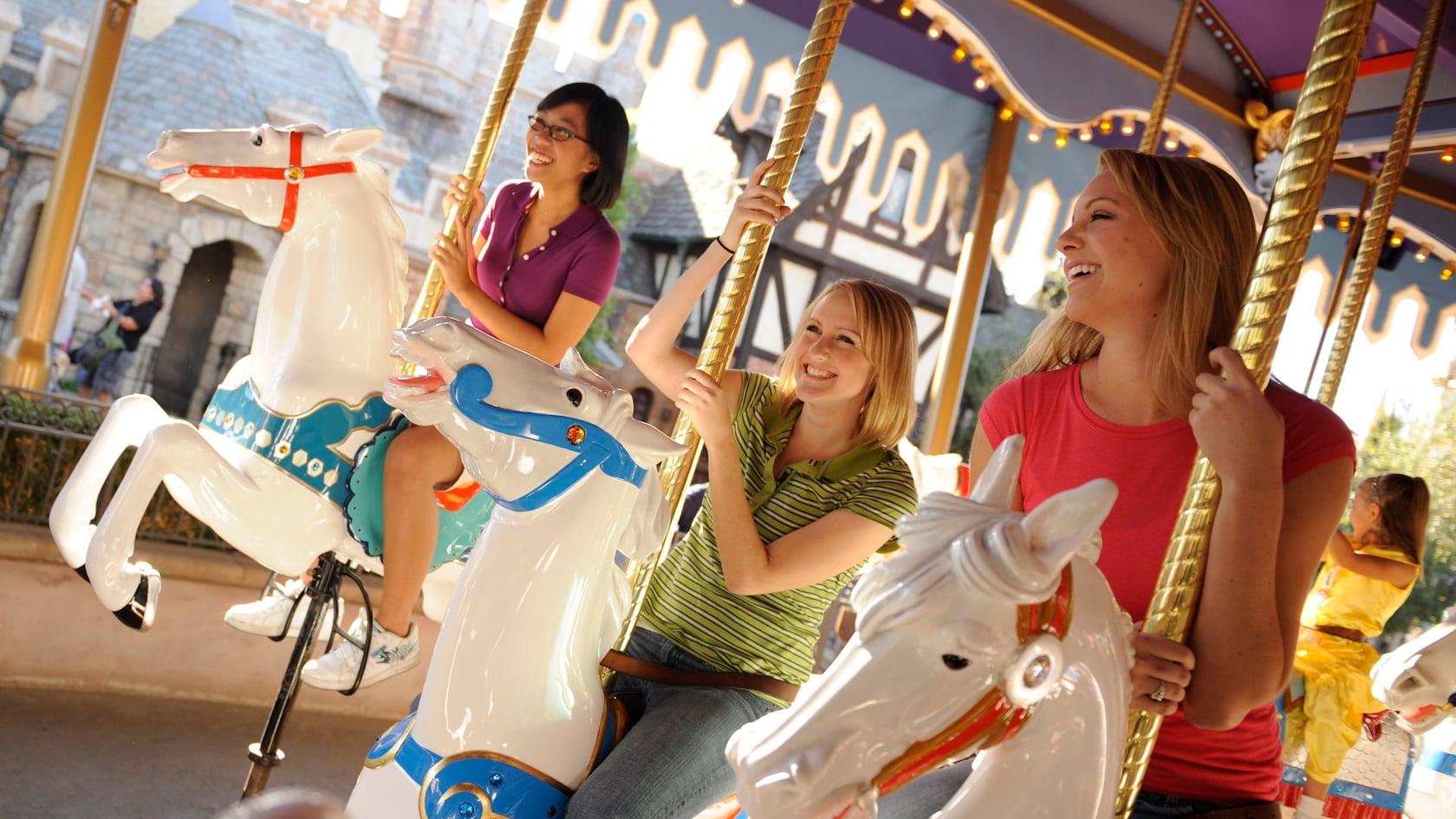 3 Guests enjoy their ride aboard King Arthur's Carrousel