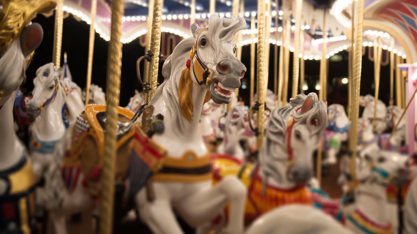 A detailed carousel horse with a lock of its mane braided, aboard King Arthur's Carrousel