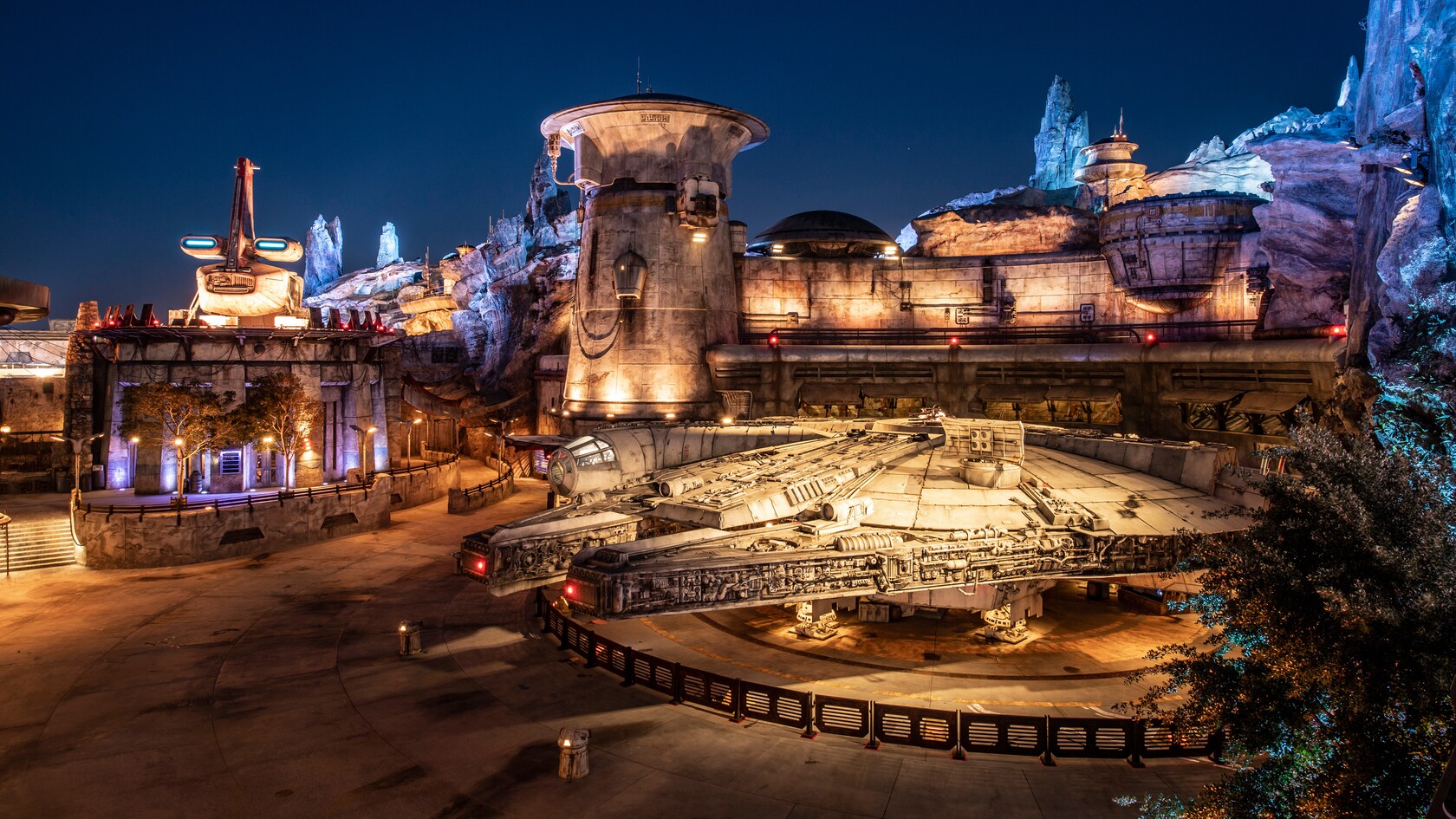 A life size replica of the Millennium Falcon in front of Ohnaka Transport Solutions in the heart of Black Spire Outpost.