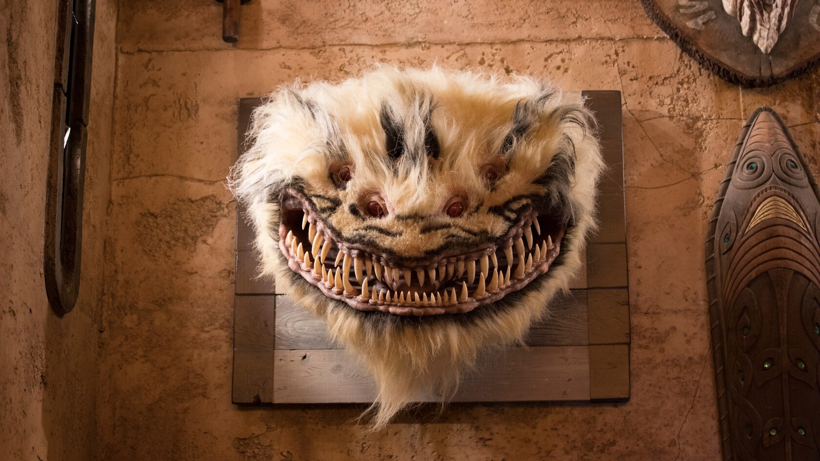 Mounted on a wall, the head of the creature known as Nexu.