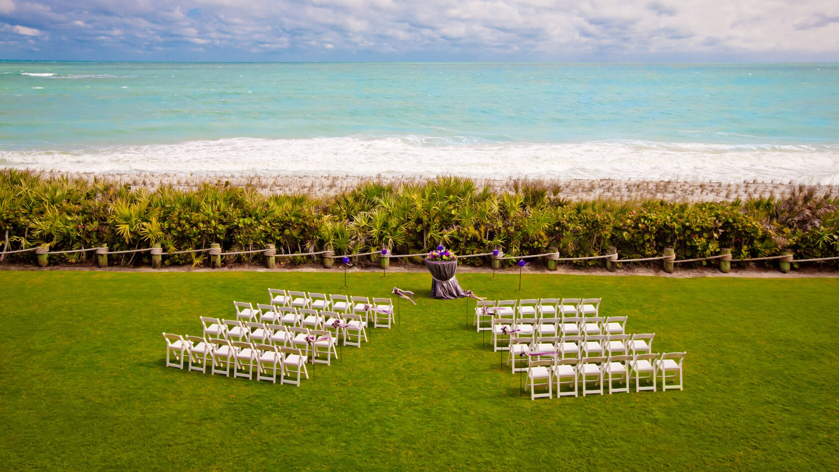 Chairs and flowers set up on the Croquet Lawn overlooking the ocean