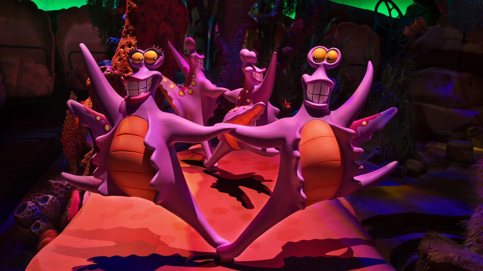 Purple sea creatures sing and dance at The Little Mermaid ~ Ariel's Undersea Adventure attraction