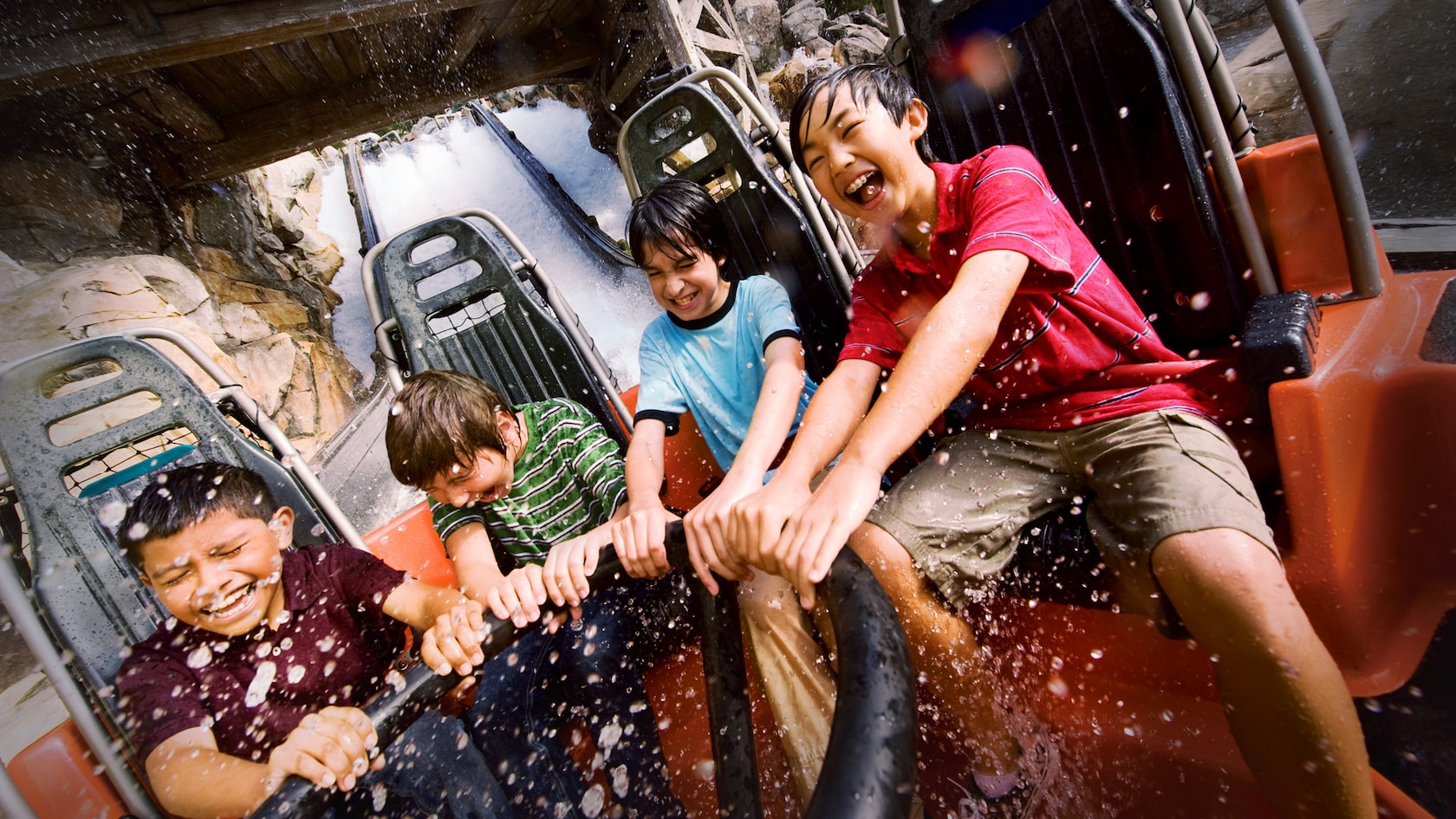 Kids laugh as they get splashed riding Grizzly River Run at Disney California Adventure Park