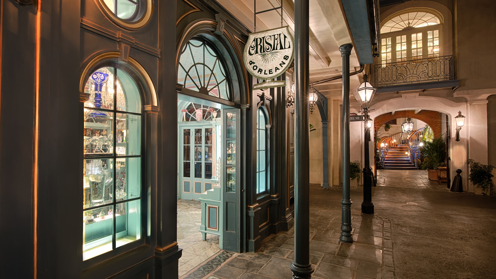 Fine crystal glassware sparkles in the evening while lining the window displays at Cristal d'Orleans