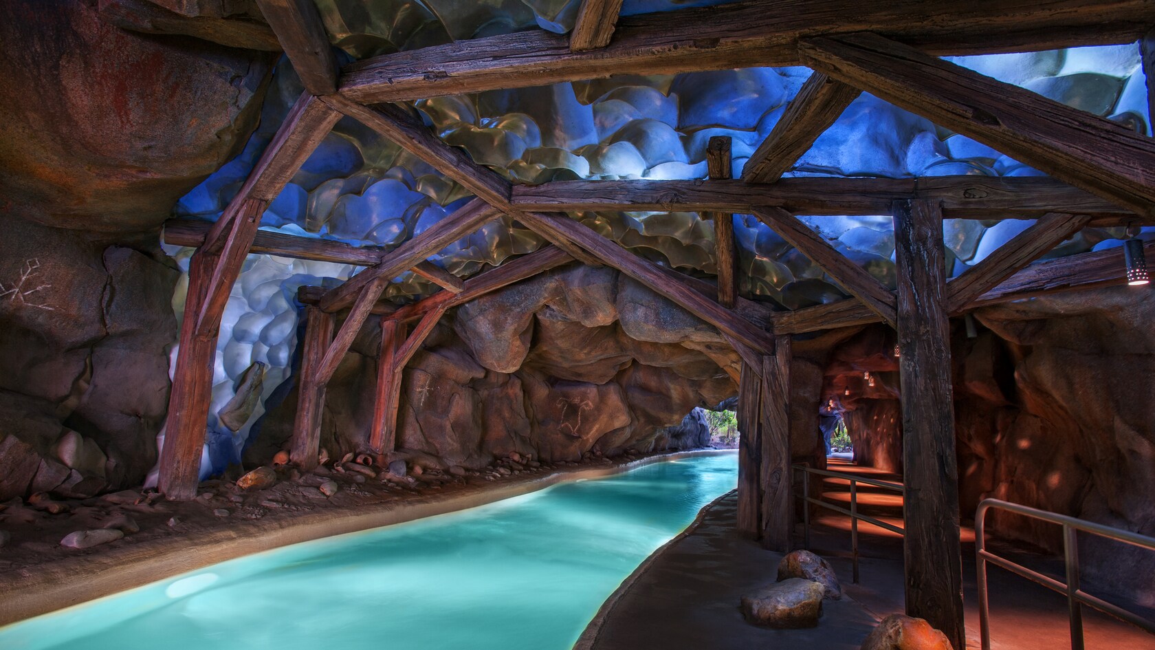 The creek flows through a huge cave supported by wooden beams