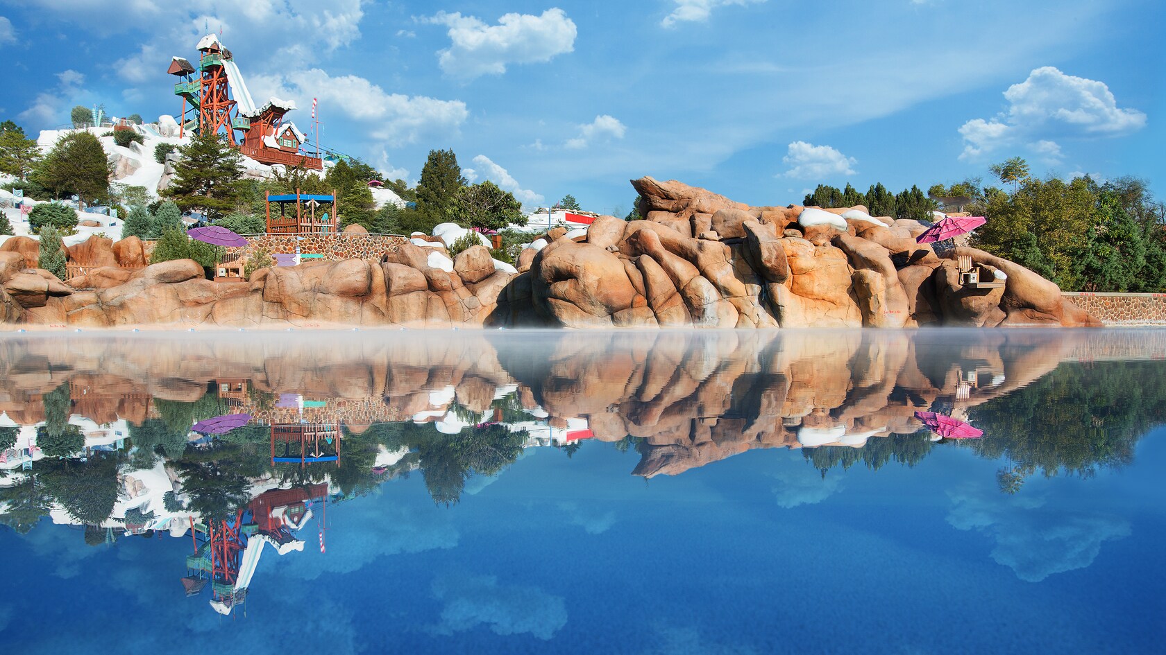 Calm waters in Melt-Away Bay reflect the water park's Mount Gushmore